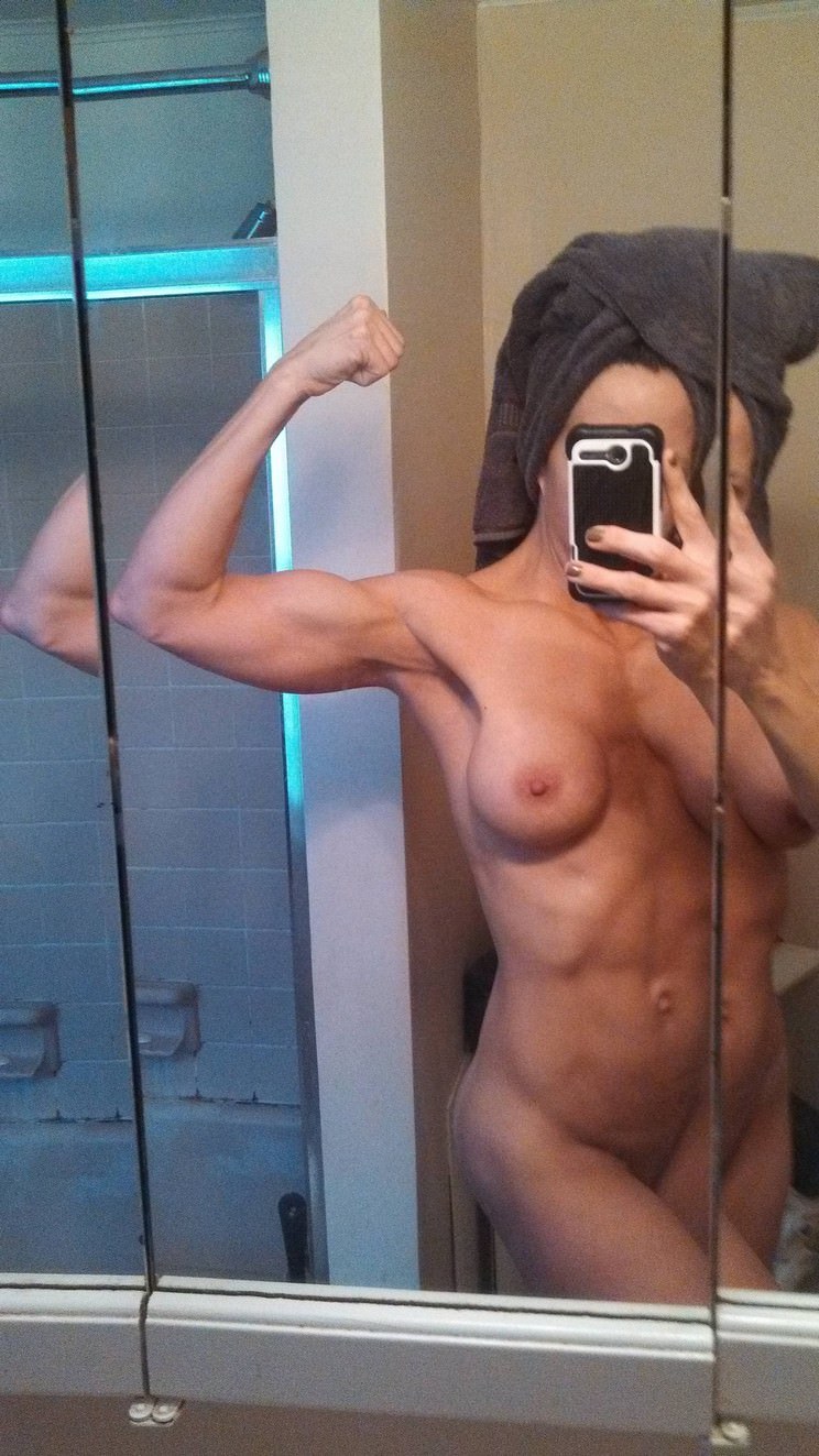 A man with a naked dick in front of a mirror