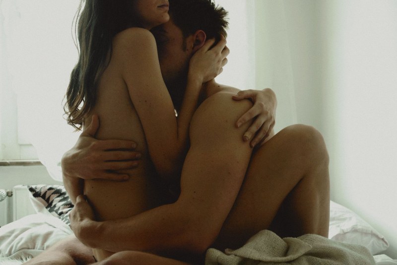 Naked man and woman hug