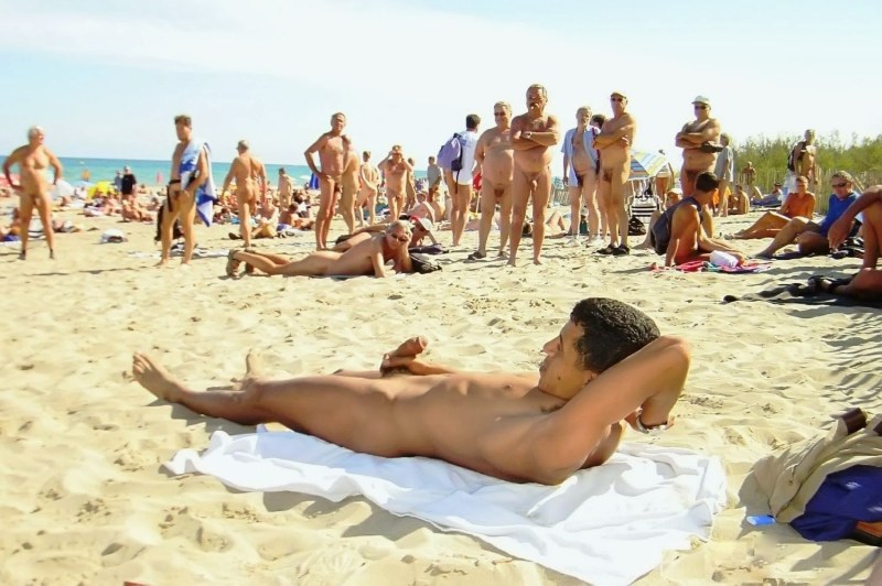 Naked men and women on the beach