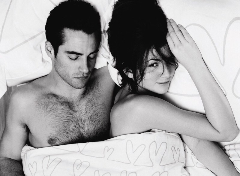 A man and feminine in bed