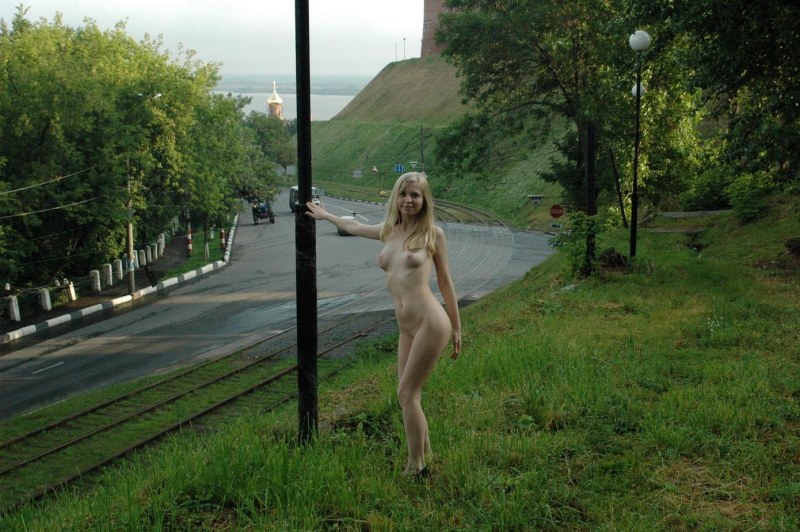 A naked woman without panties walks on the street