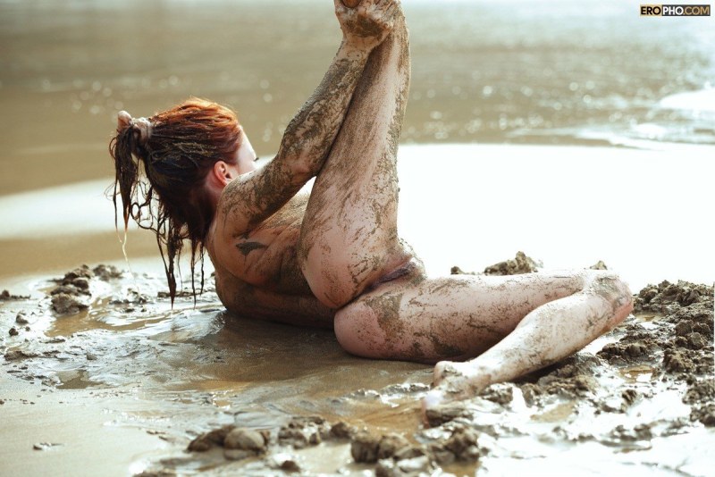 Naked women bathe in the mud