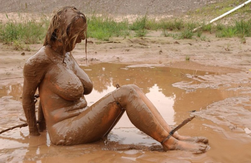 Naked women bathe in the mud
