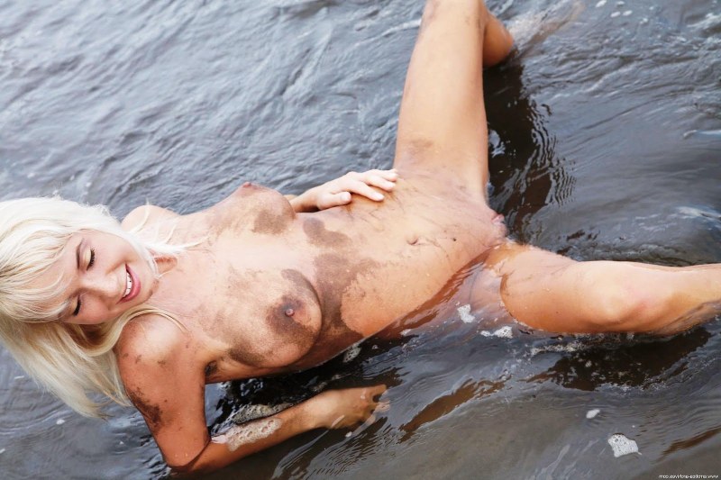 Naked woman all in mud