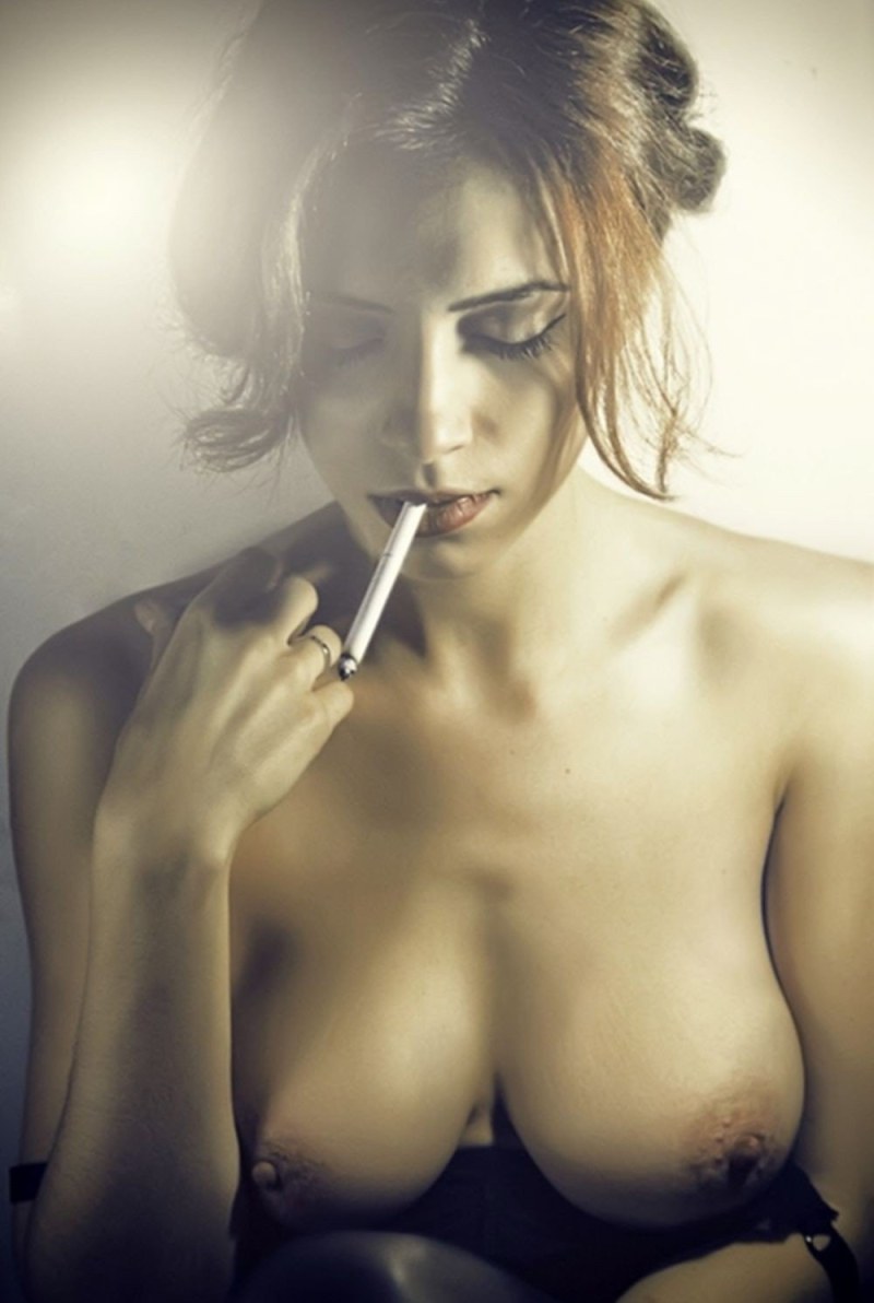The girl smokes erotically