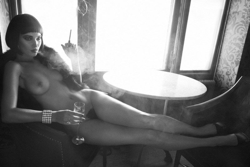 The girl smokes and undresses