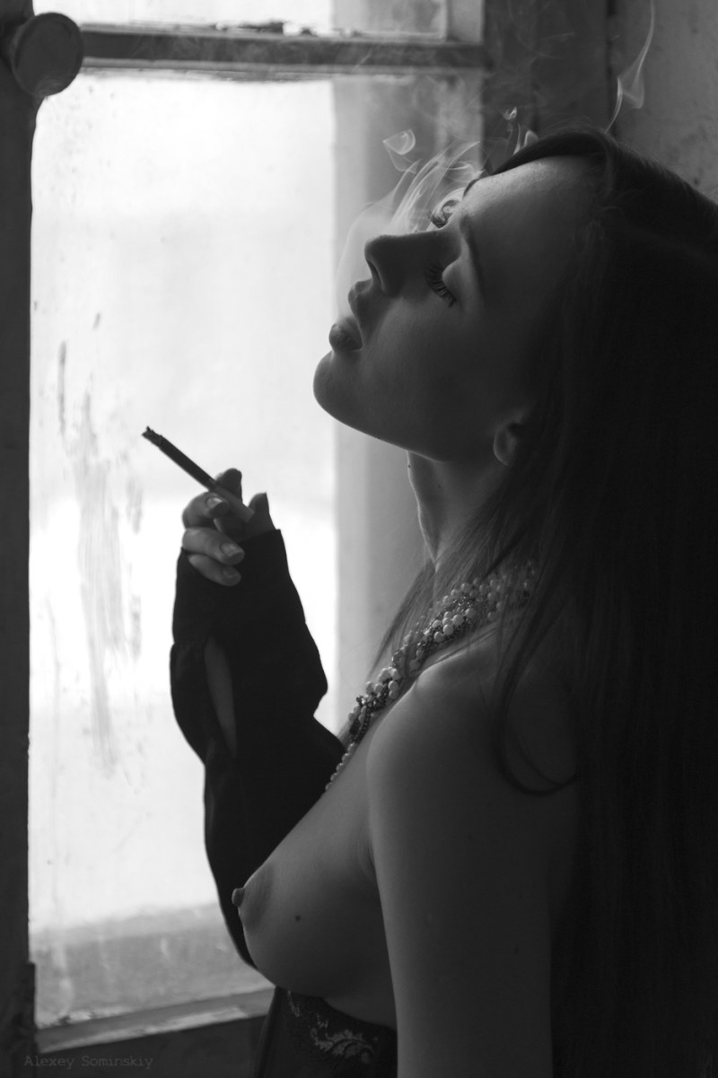 The girl smokes erotically