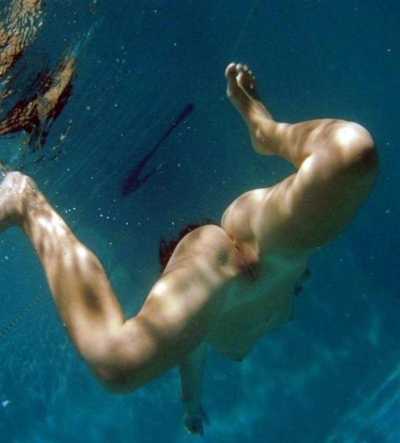 Naked swimmers underwater