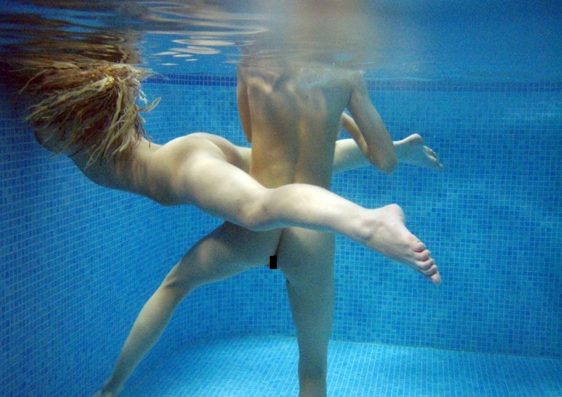 Naked swimmers underwater