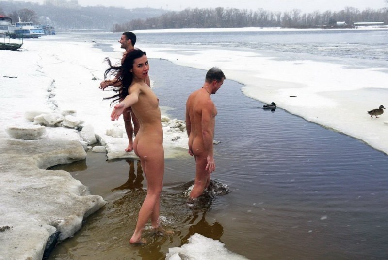 Naked blonde in an ice hole