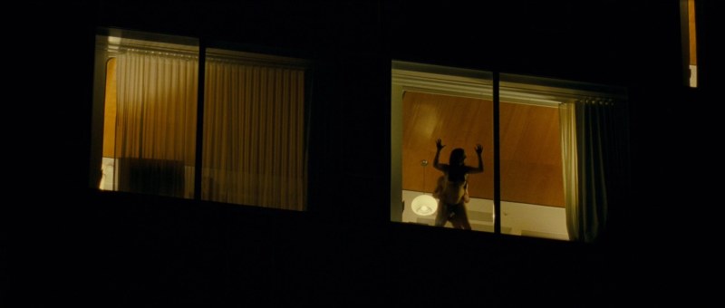 Naked women in the windows of houses