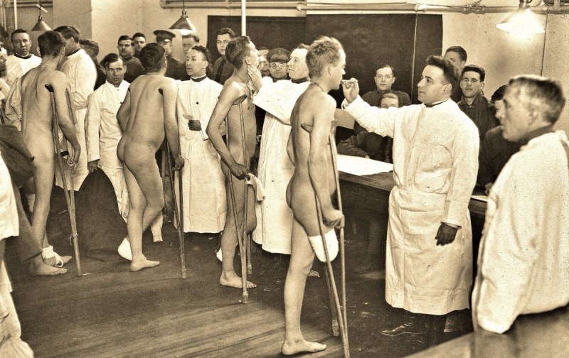 Women examine naked men