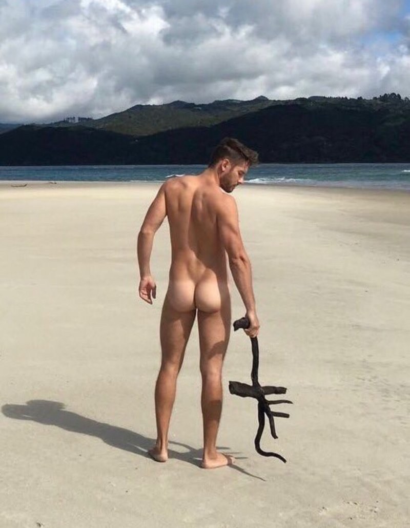 Naked men sunbathe on the beach