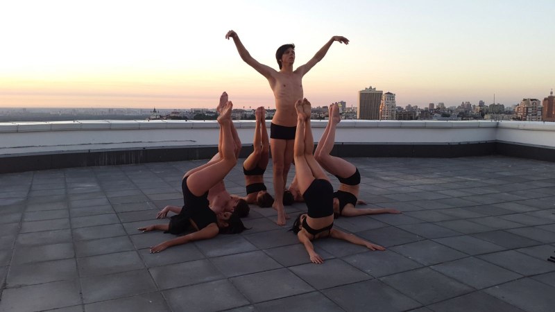 Naked girls sunbathe on the roof