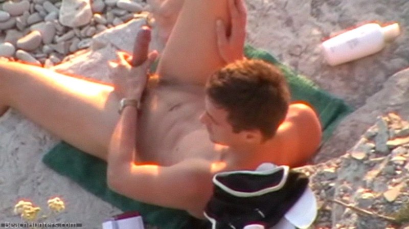 Naked men fuck on the beach