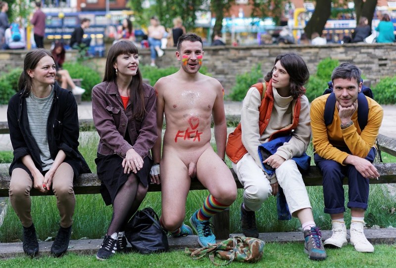 Naked women among dressed men