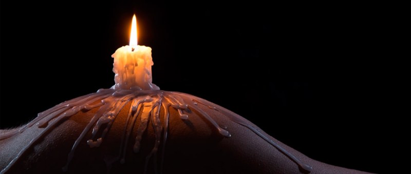 Burning candle in the ass of a girl
