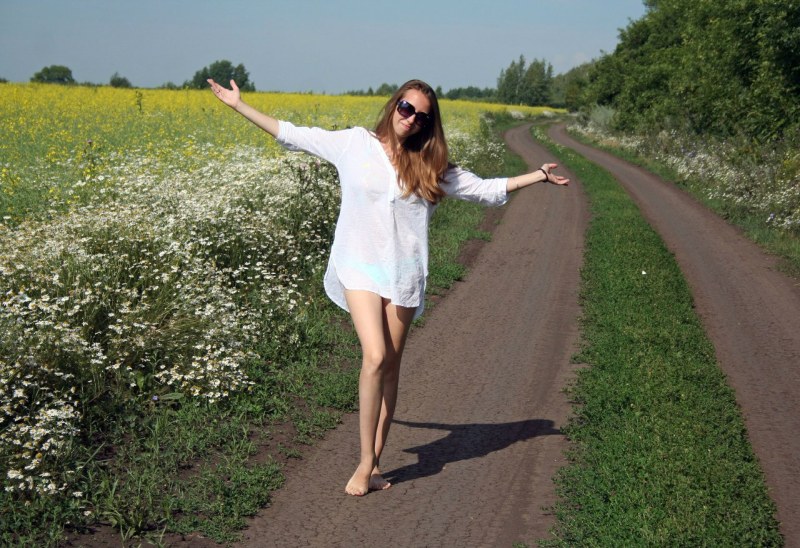 Girl in a dress barefoot on the road