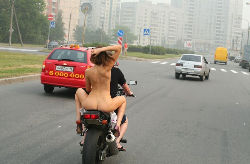 Naked on a motorcycle in the city