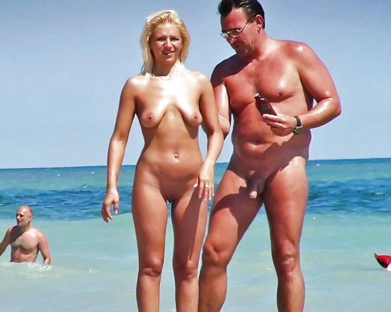 Couples sunbathe naked on the beach