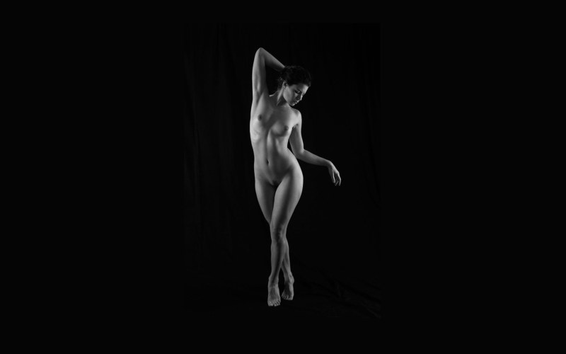 Naked woman on a black background