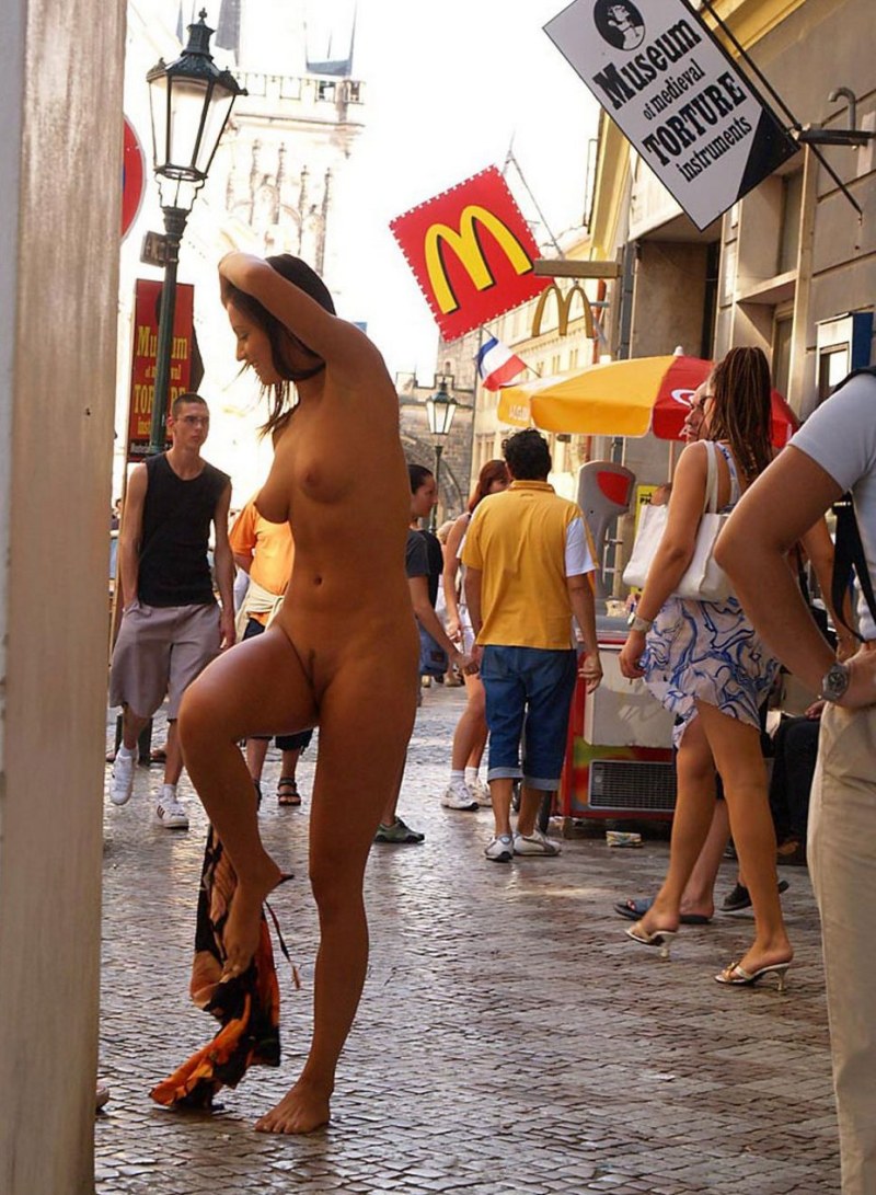 The girl undresses in a public place