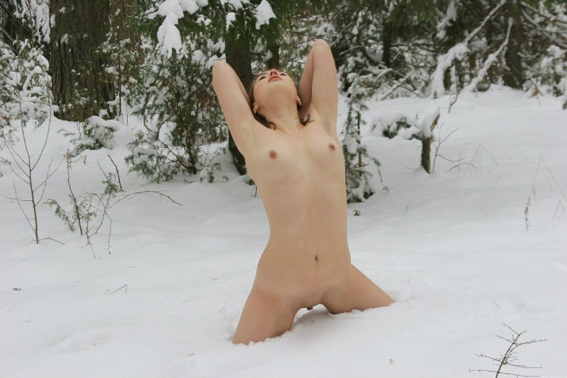 Naked blonde in the forest in winter