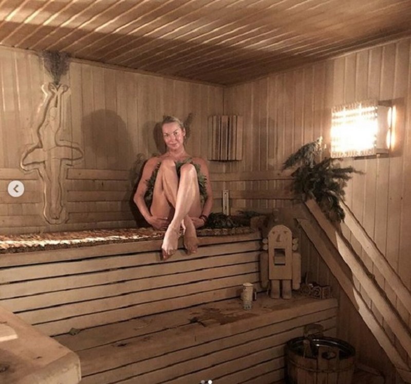 Anastasia Volochkova with a broom