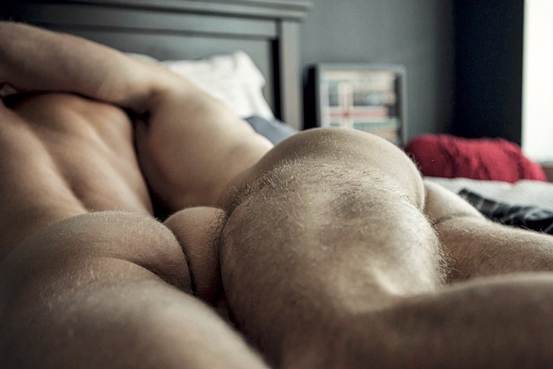 A naked hairy man sleeps