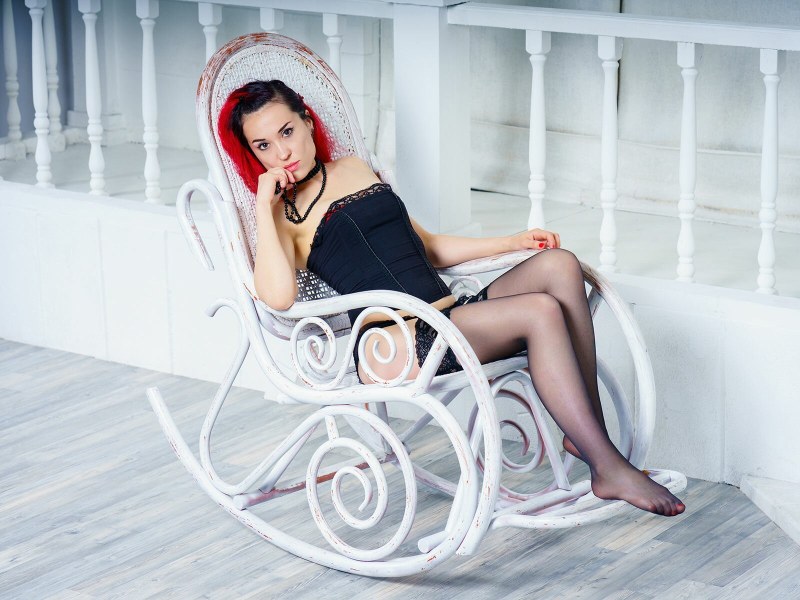 Girl in a dress poses on a tree