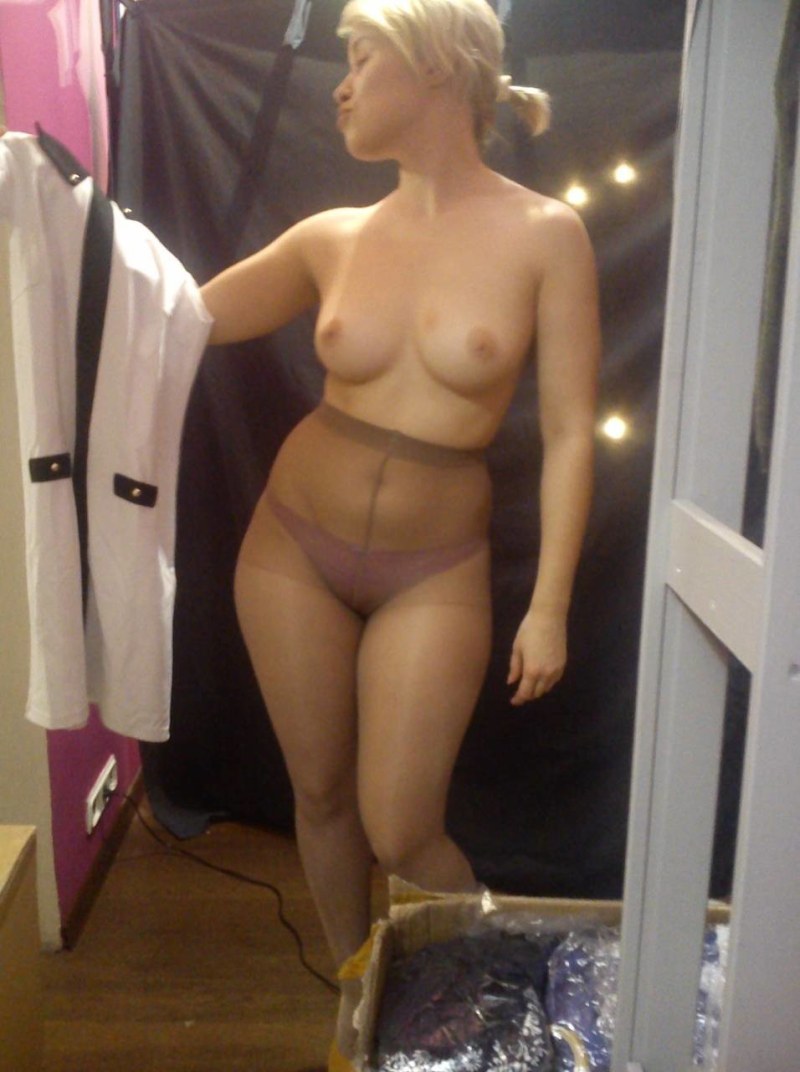 The girl dresses up in the fitting room