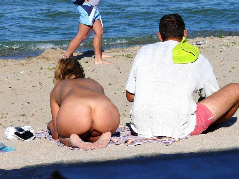 Naked women in thongs on the beach