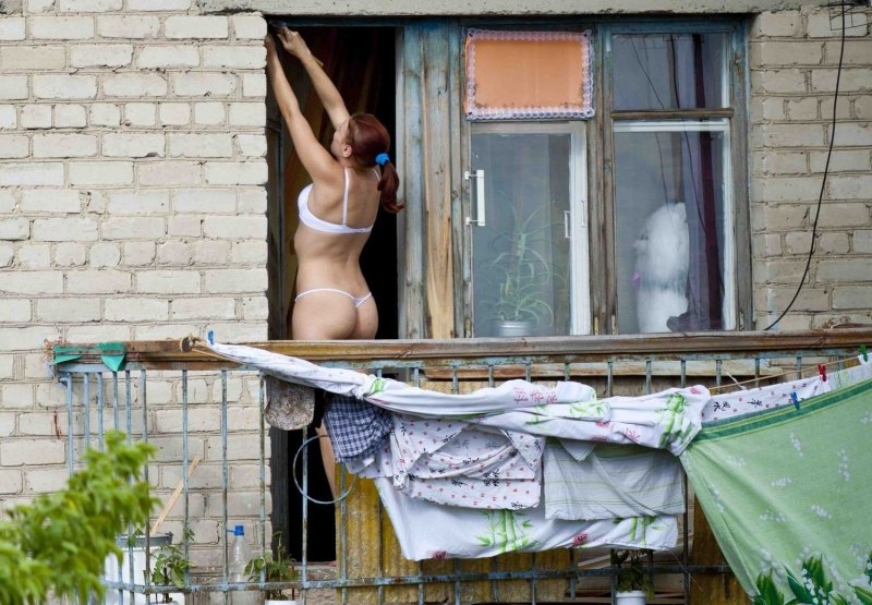 Naked women in the windows of houses