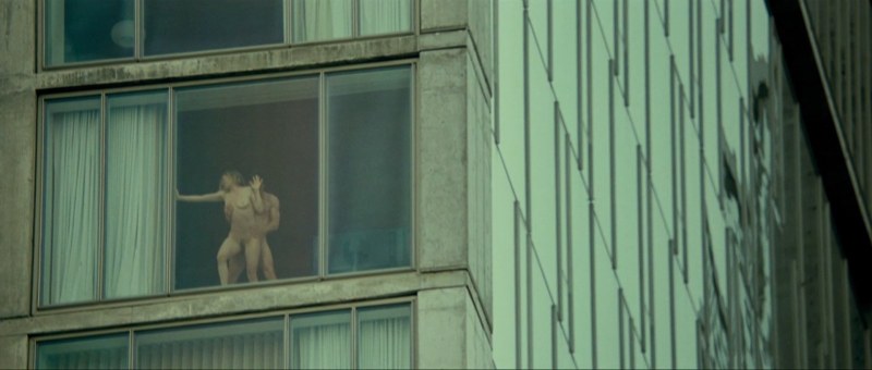 Naked women in the windows of houses