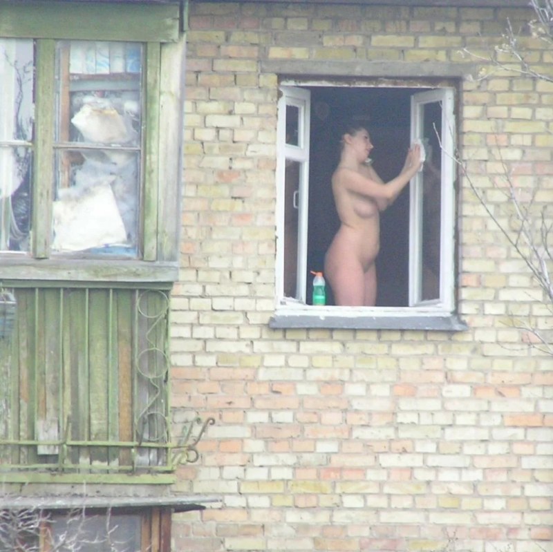 Naked women in the windows of houses