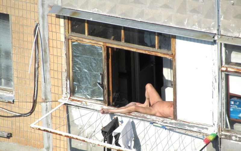 Naked women in the windows of houses
