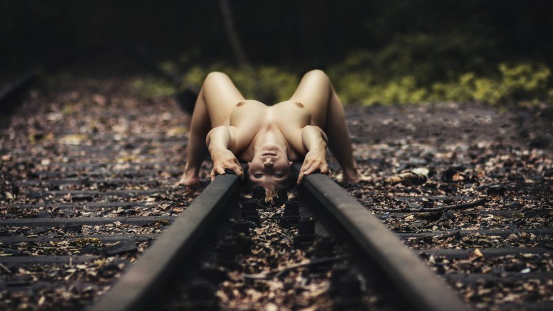 Undresses on the railway