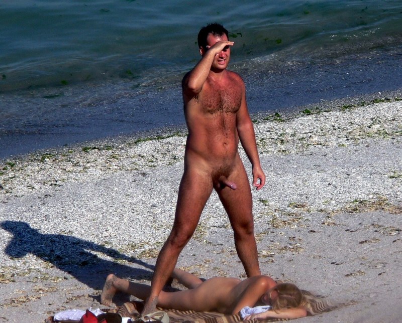 Men's naked butt at sea