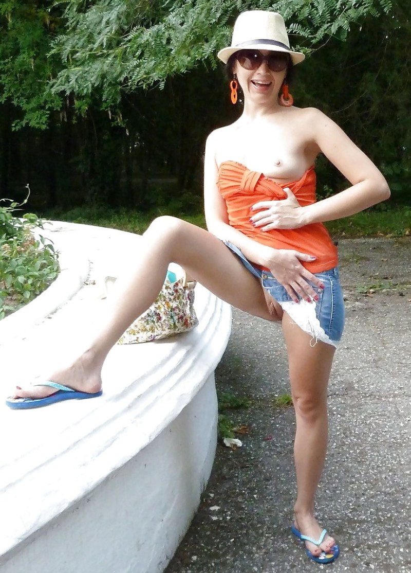 The naked redhead is sunbathing