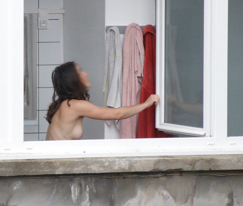 Naked women in the windows of houses
