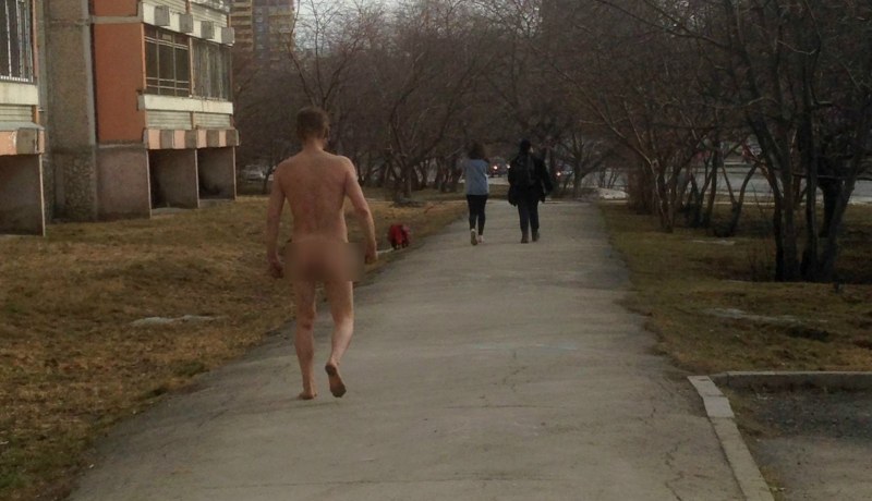 A naked man runs down the street