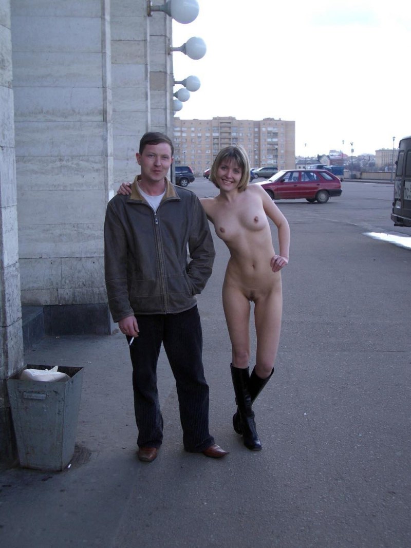 Naked woman on the street with men
