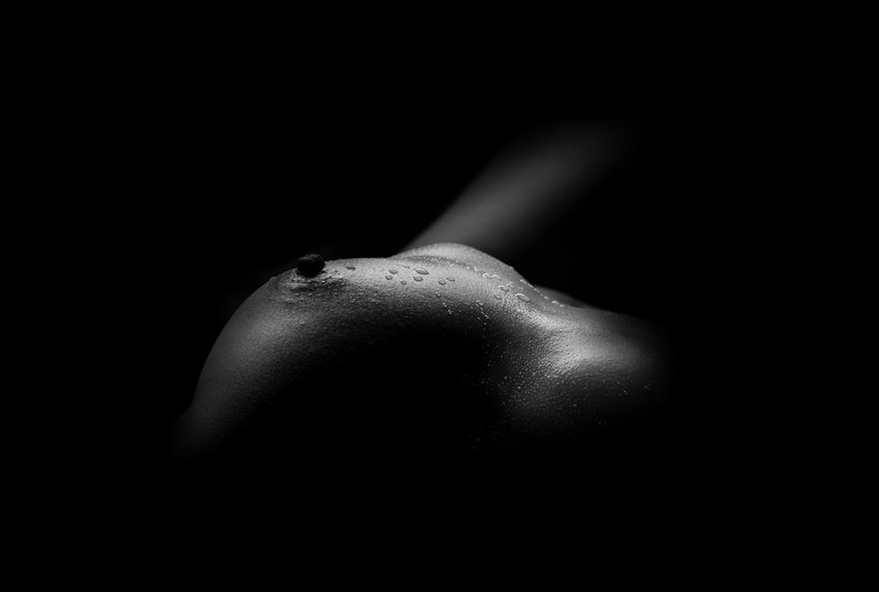 Naked boobs on a black background