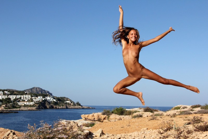 Naked gymnast in a jump