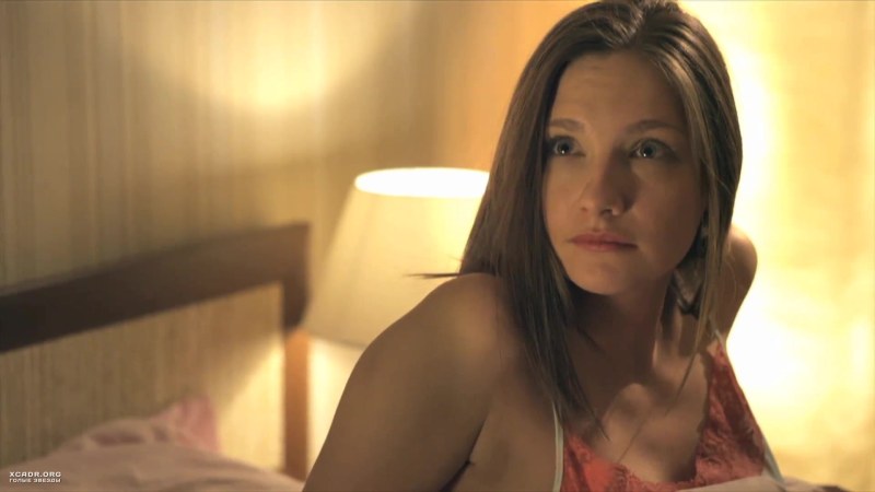 Girl in a swimsuit against the background of the wall