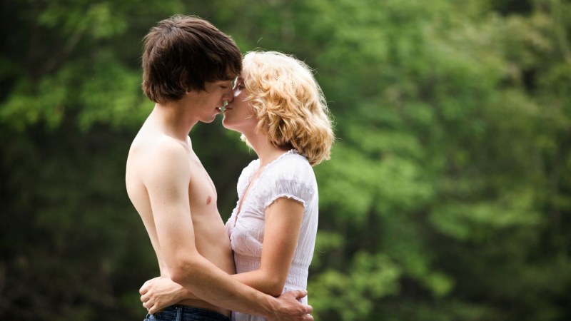 A guy with a guy in bed