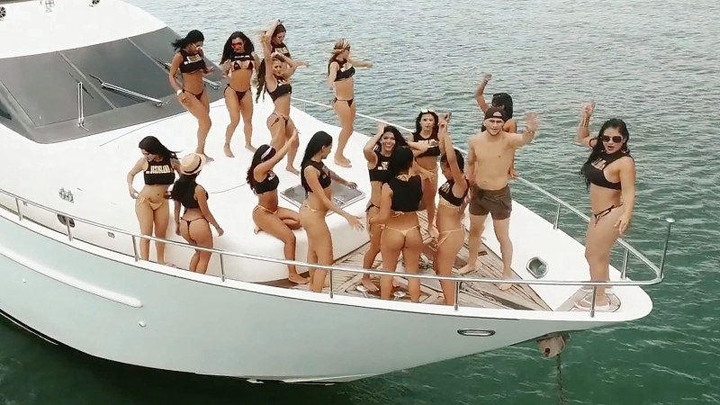 Girl Brunette behind the helm of yacht