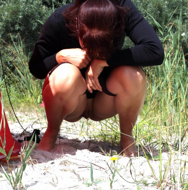 Fat woman pouring in the bushes