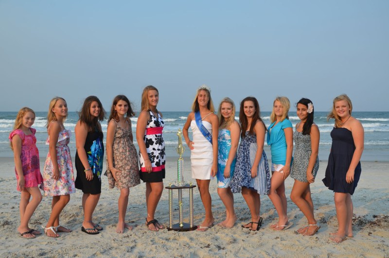 The family is sunbathing on the beach
