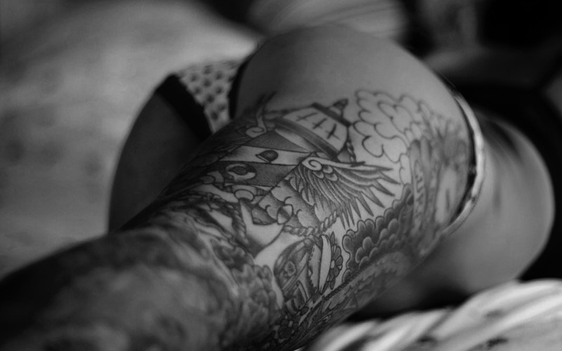 Girl with a tattoo in bed